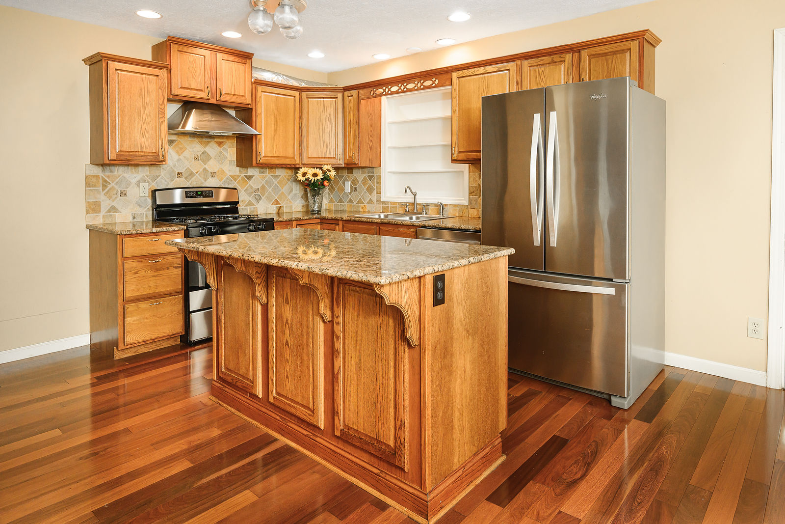 Kitchen with granite island and stainless appliances