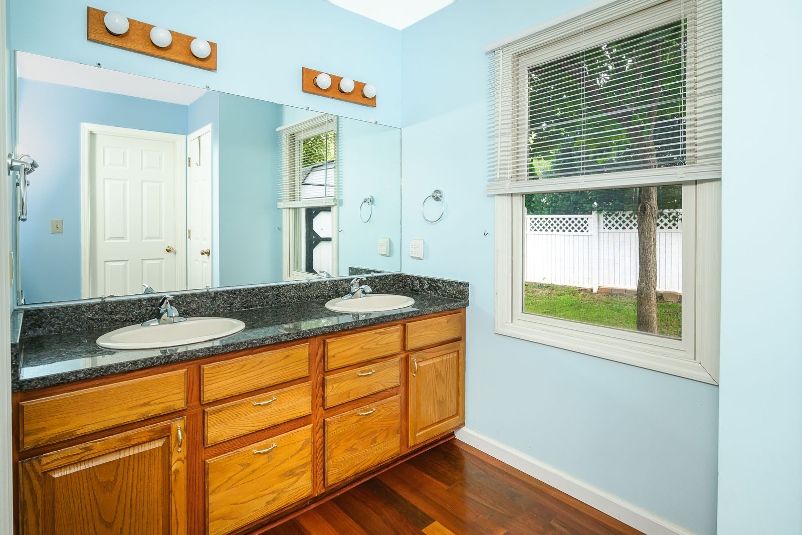 Primary bath with double vanity and a window to the garden